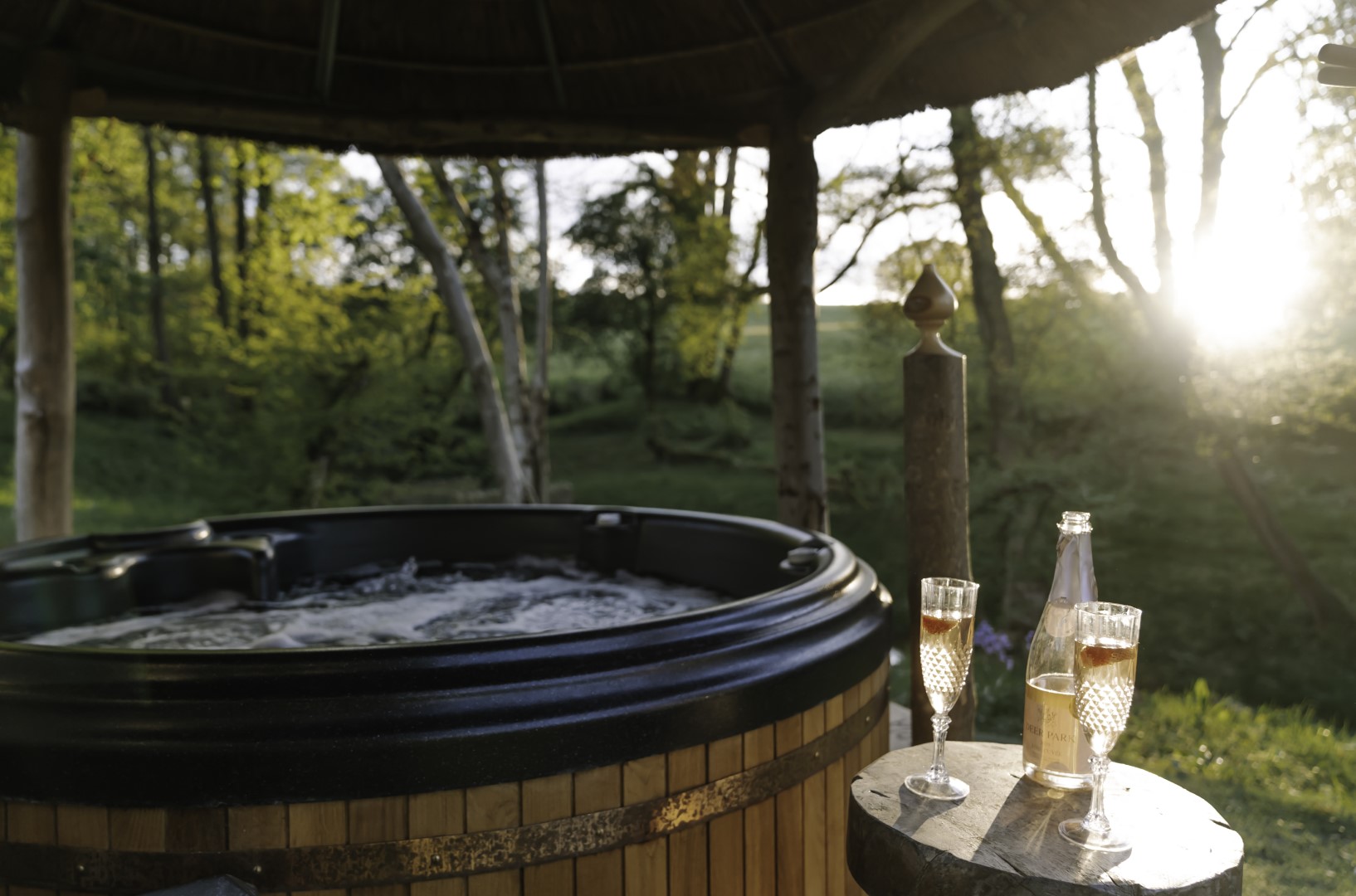 Treeopia Romantic Hot Tub for two with wine glasses | Minimoon in the UK