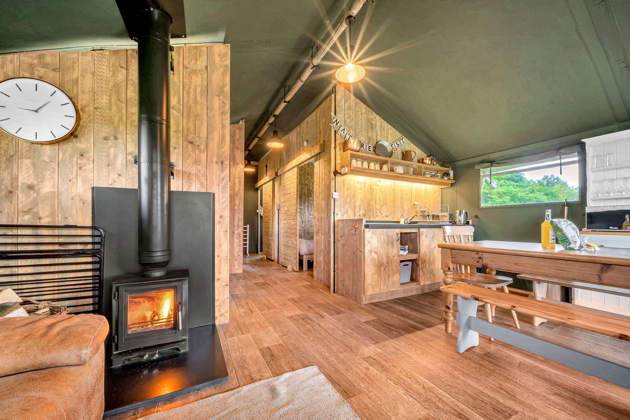 Wooden interiors and log burner at Nature's Nest Glamping Herefordshire